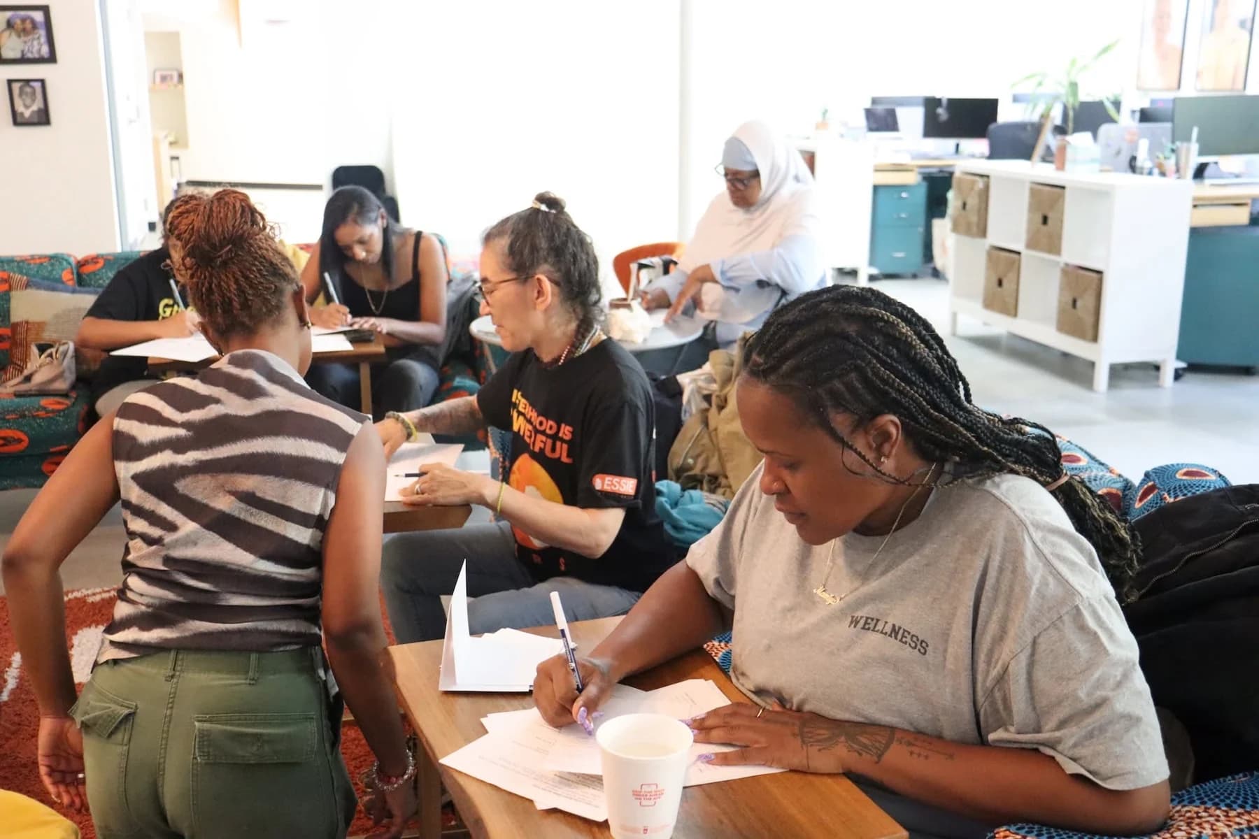 Participants working together around tables.